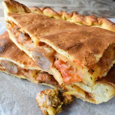 Schiacciata pizza filled with potato and pork sausage