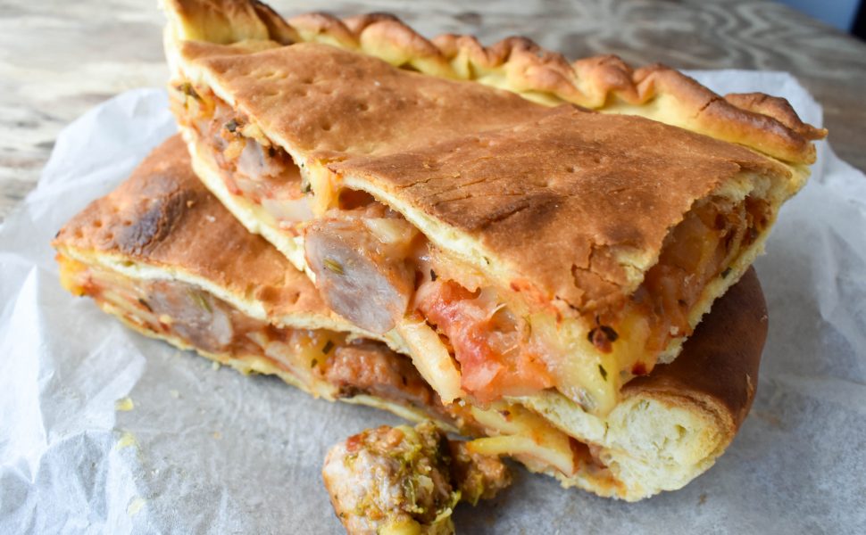 Schiacciata pizza filled with potato and pork sausage