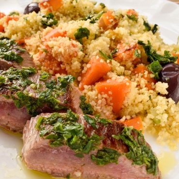 Herbed lamb backstraps with roast vegetable couscous