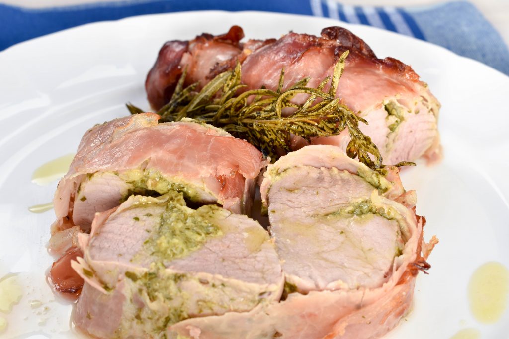 Pancetta wrapped roast pork fillet with salsa verde stuffing Italian