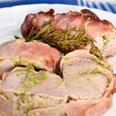 Pancetta wrapped roast pork fillet with salsa verde stuffing