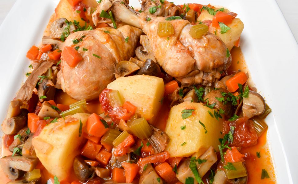 Chicken drumsticks with mushrooms, potatoes and tomatoes