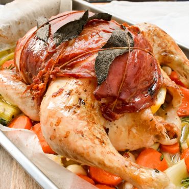 Roast chicken wrapped in sage and prosciutto